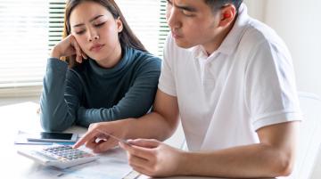 couple with credit cards and calculator