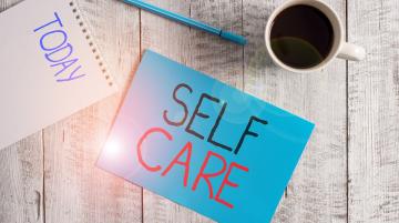 Self care written on blue post it