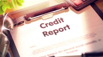 credit report and pen on clipboard