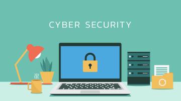 On desktop are a laptop with a padlock on the screen. Words "Cyber Security" above laptop. A lamp, coffee mug, and plant to the left of laptop; other office items to right.