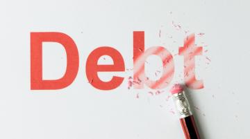 An eraser wiping out the word "Debt," which is in red type.