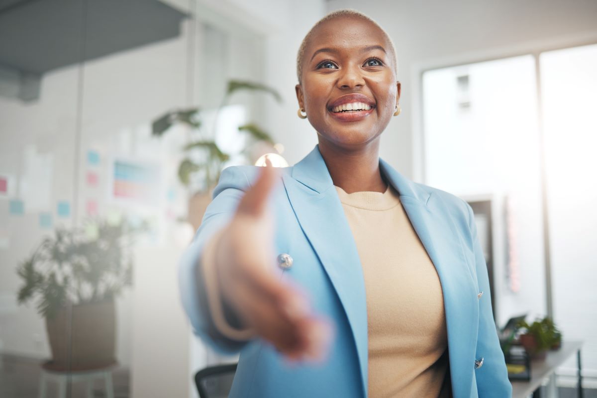 A Young professional reach out to shake hands.