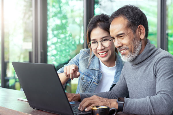 Woman and man looking at a laptop