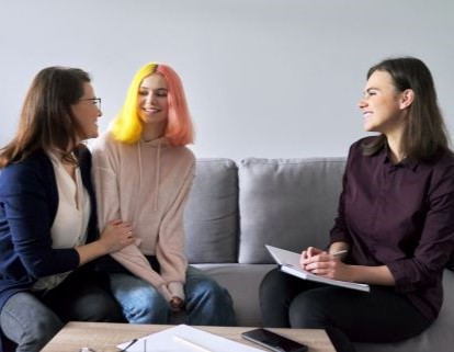 Social worker, psychologist at meeting with mature woman and her teenage daughter