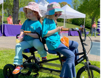 Finley and Meredith riding a bike