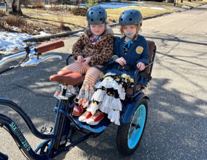 Finley and Meredith riding a bike