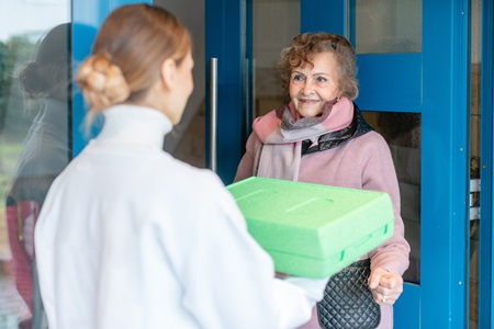 LSS Meals on Wheels volunteer delivering meals to an older adult