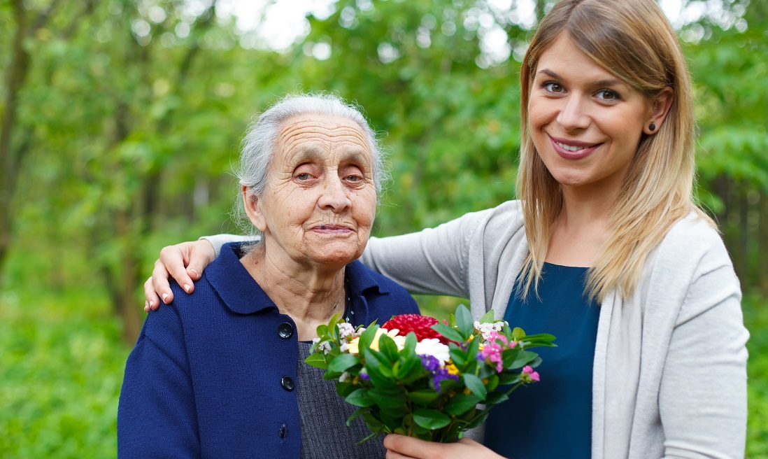 Women holding a bouquet of flowers