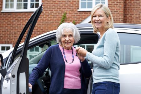 Older Adult being assisted by friendly helper 