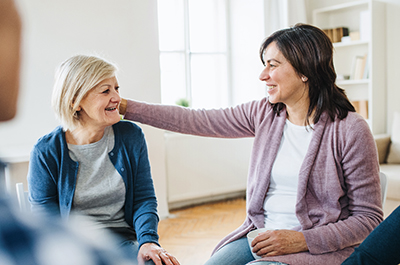 Two women sitting at caregiver support group