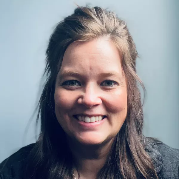 Jennie Bell; adult woman with brown, shoulder-length hair smiling for camera