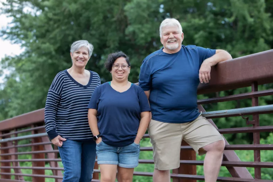 From left to right: Janet, Rosa and Ron pose for a picture on a bridge.