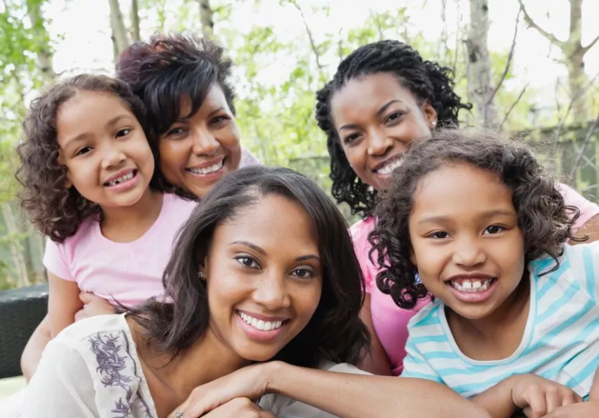 Kinship family sitting together outdoors on a patio set