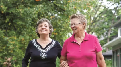 Older adults walking outside. 
