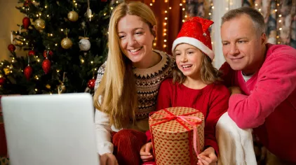 Family with computer and Christmas tree
