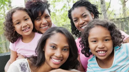 Kinship family sitting together outdoors on a patio set