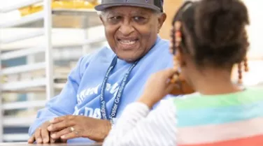 foster grandparent volunteer with child
