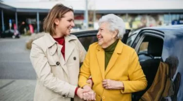 Older Adult being assisted by friendly helper