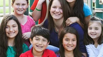 People smiling together on a playground