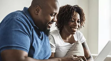 Two individuals looking at a computer